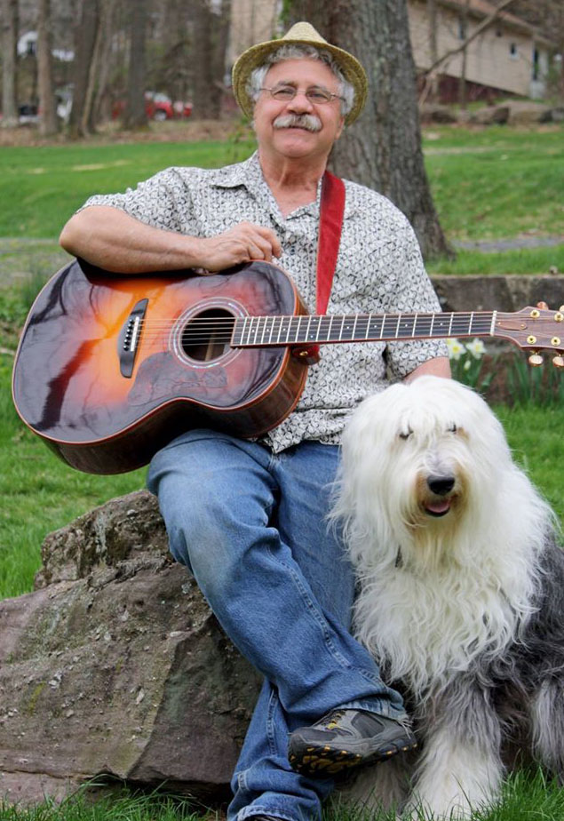 Toby, John's Old English Sheepdog, keeps watch as he prepares to play.